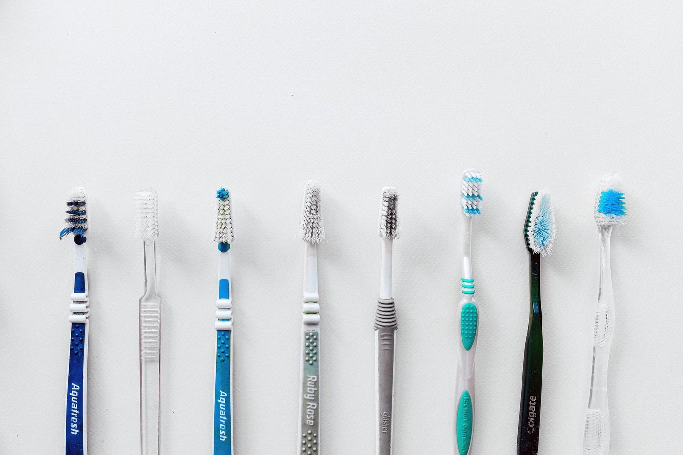 Cepillos de dientes alineados sobre fondo blanco